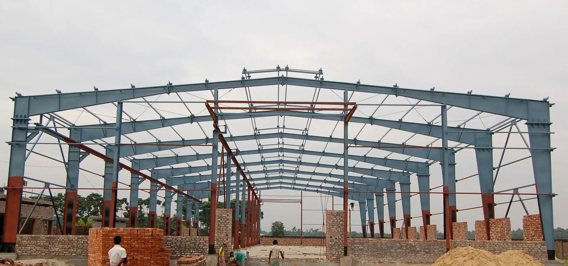 Heavy-duty I-beam installation for a pre-engineered building in India project
